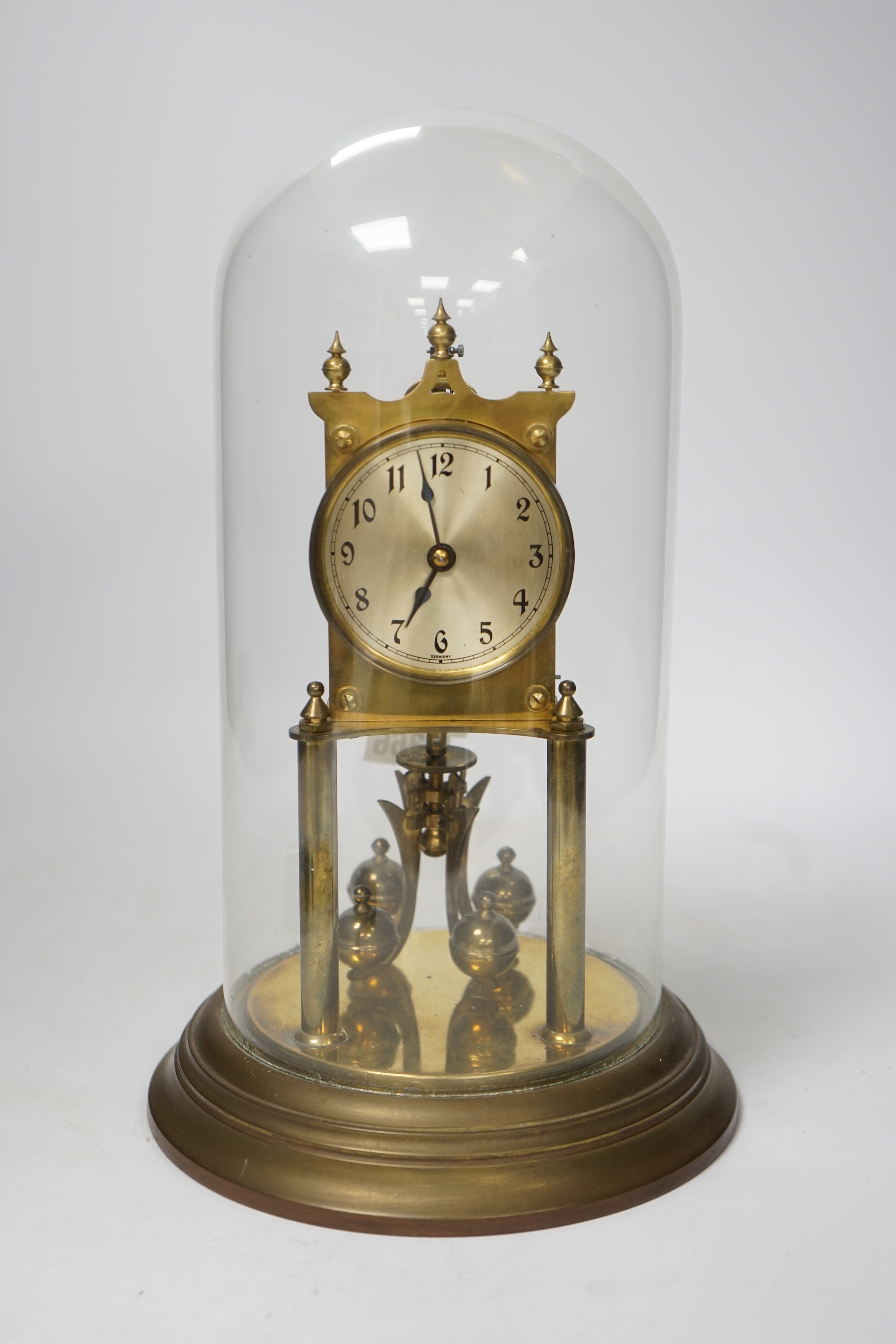 A 20th century German brass torsion pendulum clock under brass dome, 32cm high